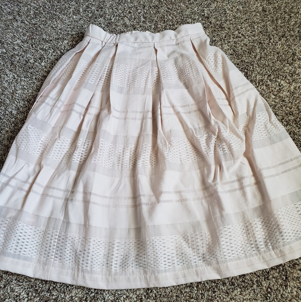 Contemporary skirt, pale pink creme color.